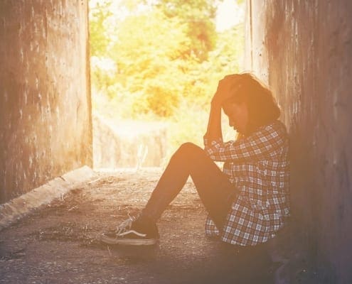 Coping With Teenagers - Young Dark Skinned Girl In Tunnel With Depression and Anxiety. Counselling Melbourne.