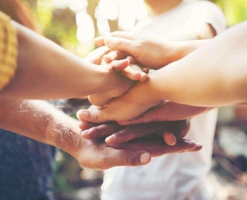Mental Ask For Support Min - Group of people showing support and holding hands.