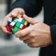 Mental Health Solving Problems - Man with ruby cube working out problems concept.