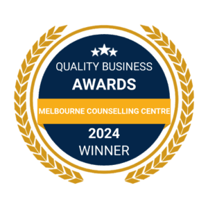 Digital Badge Melbourne Counselling Centre A circular badge with a blue background and golden laurel leaves around the edge. The top of the badge features three white stars. It reads "Quality Business Awards, Counselling Melbourne, 2024 Winner".